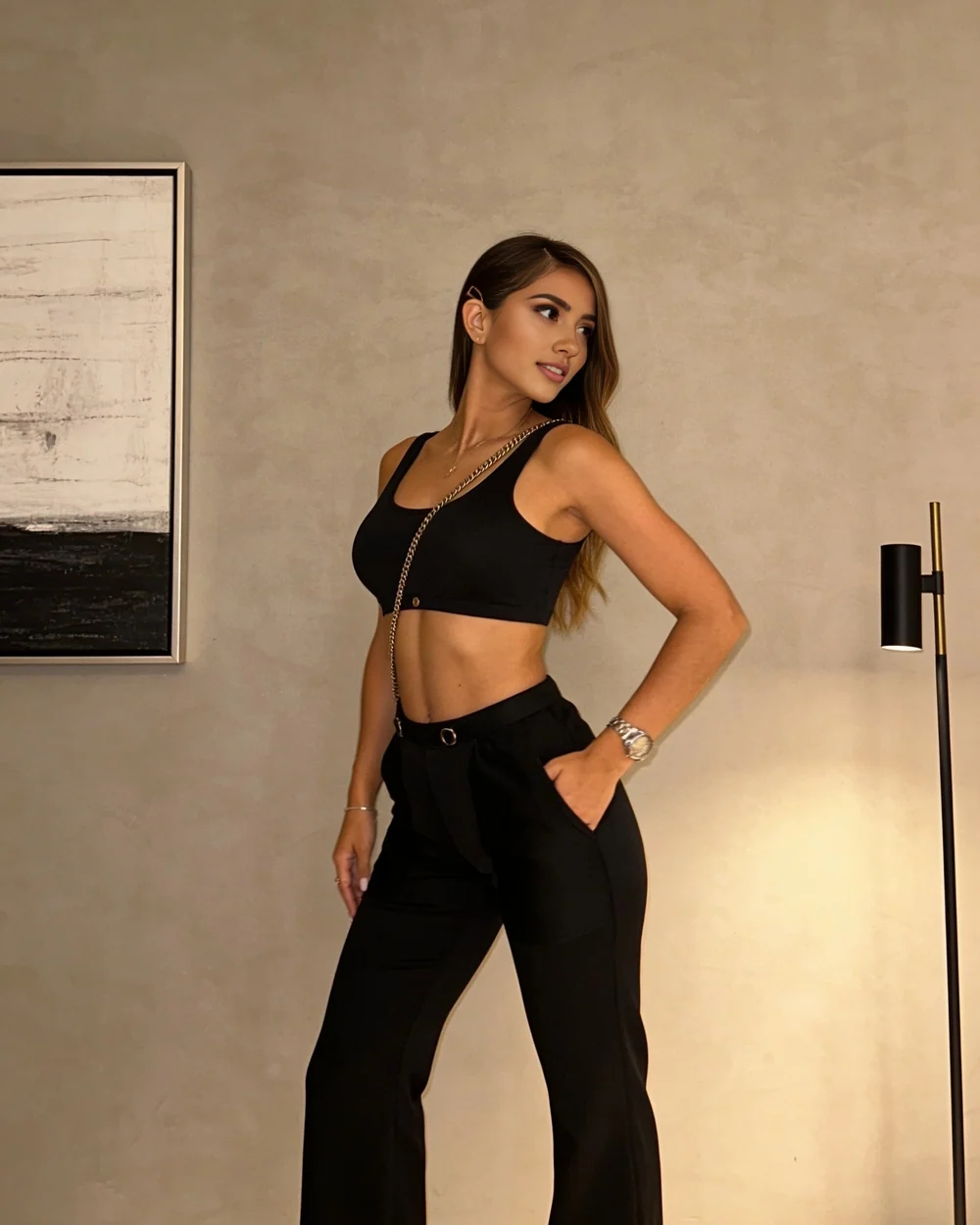 Catalina in a black top and tailored trousers